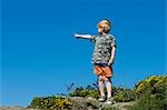 UK,Wales,Pembrokeshire. A young boy looks out from Dinas Head on a walk along the Pembrokeshire Coastal Path .