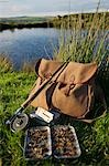 UK,Wales,Conwy. A trout rod and fly fishing equipment beside a hill lake in North Wales