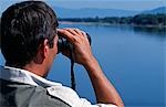 Zambia,Lower Zambezi National Park. Guide,David Keys,surveys the banks of the Zambezi River for game.