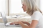 Woman at Home Using Laptop Computer