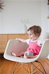 Baby Girl Sitting in a Rocking Chair