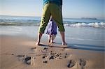 Back View of Mother and Young Daughter on Beach, Long Beach, California, USA