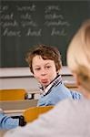 Student Sticking His Tongue Out at His Classmate