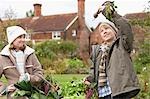 Children picking vegetables from garden