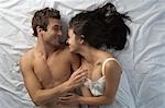 Couple in bed laughing,high angle