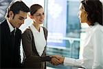 Businesswoman greeting young couple