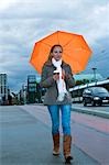 Woman Walking Down the Street in the Rain