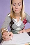 Young Woman Writing in Notebook