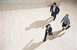 Businesspeople running in lobby