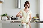 Woman pouring milk onto cereal