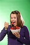 Teenage Girl Eating Bowl of Berries