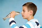 Boy Holding Raw Fish