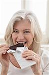 Mature Woman Eating Chocolate