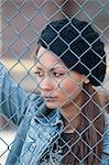 Portrait of Woman behind Fence