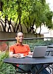 Man Using Laptop Computer at Cafe