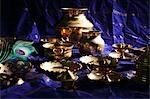 Still life of Indian brass bowls and cups on table