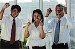 Three Indian people smiling making hand gestures