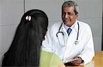 Indian doctor talking to female patient