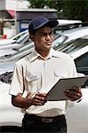 Security guard writing on clipboard