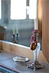 Soap dish and candle in front of a mirror