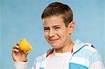 Boy Eating a Lemon