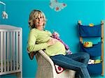 Pregnant mature woman knitting