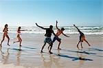 Young group frolicking on beach