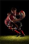 Rugby player being tackled and scoring