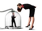 Businesswoman looking at Businessman inside of Pressurized Glass Dome