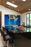 Blue splashback in black gloss kitchen