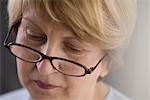 Mature woman in reading glasses