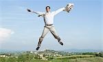 Businessman flying with his arms outstretched