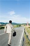 Businessman walking on the road
