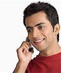Close-up of a young man talking on a mobile phone and smiling