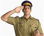Portrait of a policeman saluting
