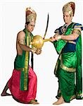 Two young men fighting in a character of Hindu epic