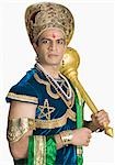 Young man dressed-up as Bhima and holding a mace