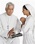 Nun confessing in front of a priest