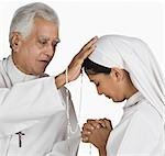 Nun confessing her sins to a priest