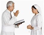 Nun confessing her sins to a priest