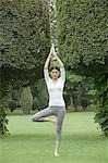 Woman practicing yoga in a park