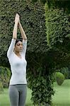 Woman practicing yoga in a park