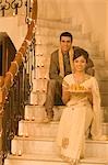 Couple sitting on a staircase and smiling