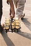 Tea vendor holding tea, Delhi, India