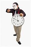 Mime showing a clock