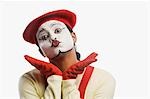 Portrait of a mime puckering lips