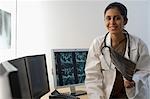 Portrait of a female doctor holding an X-Ray report and smiling