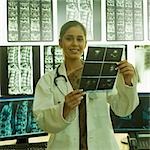 Portrait of a female doctor holding an X-Ray report and smiling