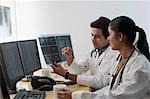 Female doctor with a male doctor examining an X-Ray report