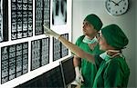 Surgeons examining X-Ray report